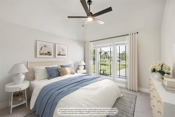a bedroom with a large bed and a chandelier fan