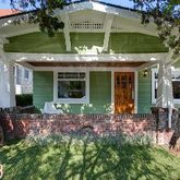 a front view of house with yard and outdoor seating