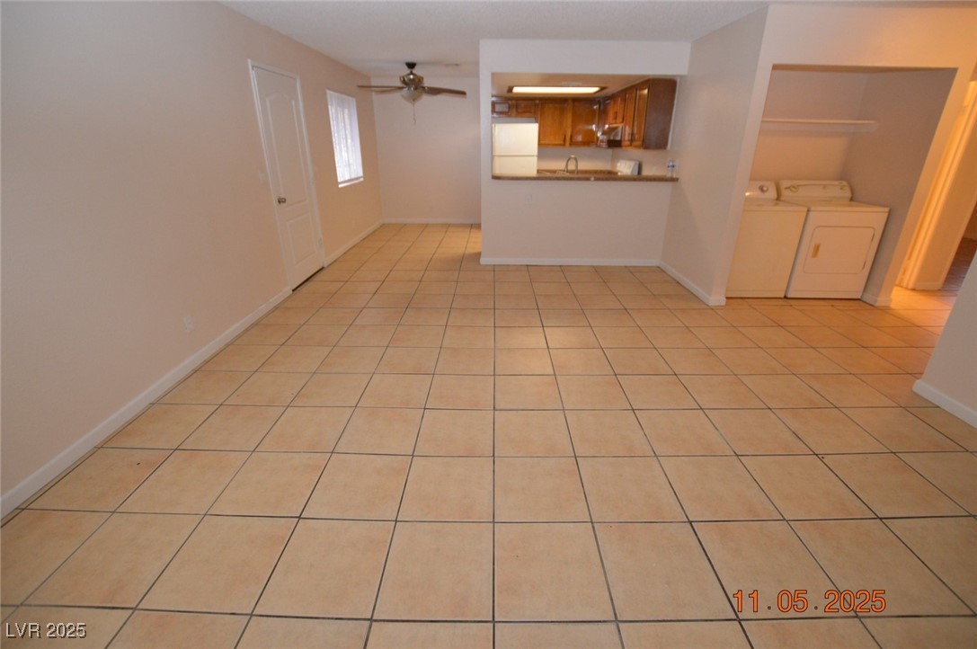 3240 North Mary Dee Avenue, Unit D North Las Vegas, NV 89030 - Photo 3 of 10 Unfurnished living room featuring light tile patterned floors, ceiling fan, and washing machine and dryer
