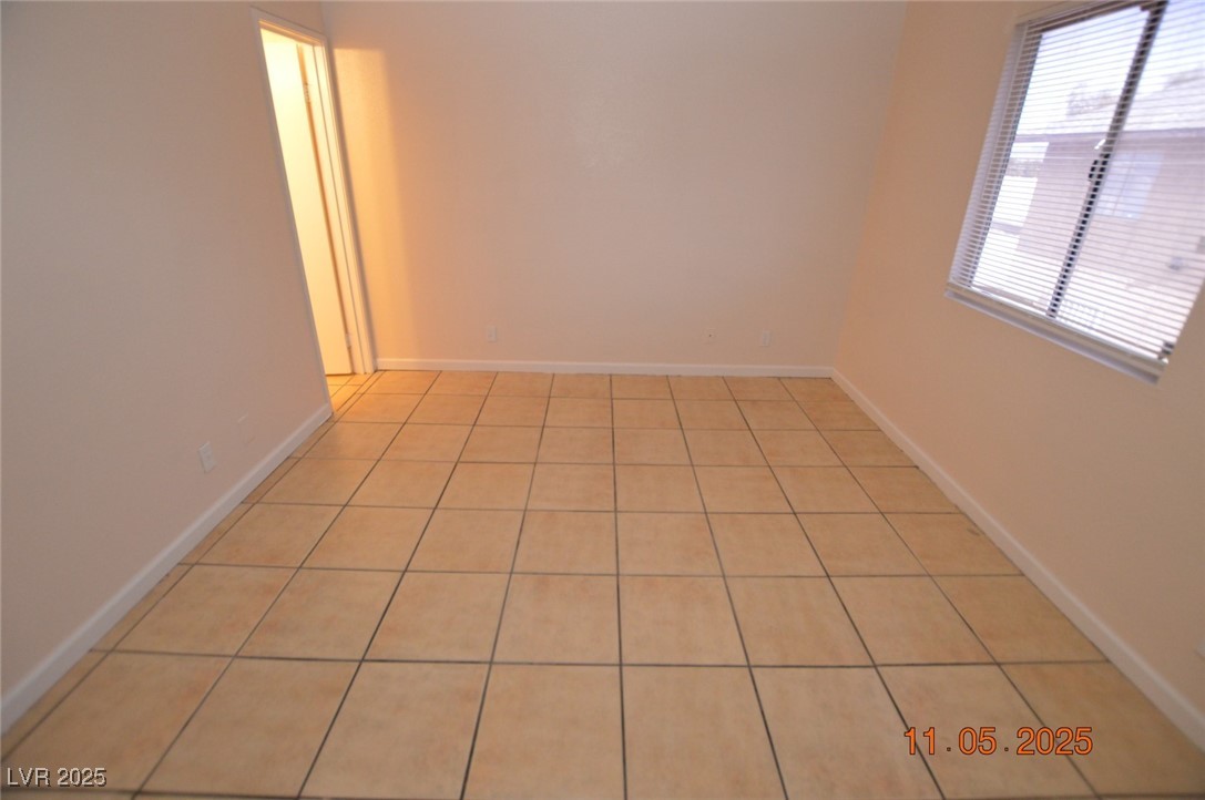 3240 North Mary Dee Avenue, Unit D North Las Vegas, NV 89030 - Photo 6 of 10 Empty room featuring light tile patterned flooring and baseboards