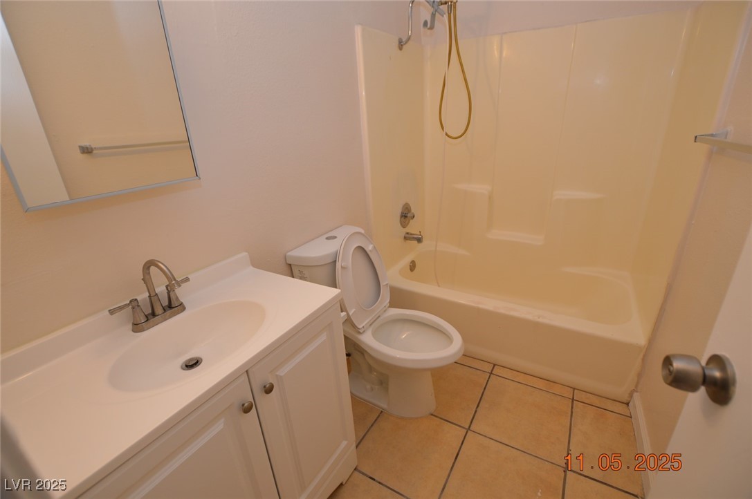 3240 North Mary Dee Avenue, Unit D North Las Vegas, NV 89030 - Photo 7 of 10 Full bathroom featuring vanity, light tile patterned flooring, and bathing tub / shower combination