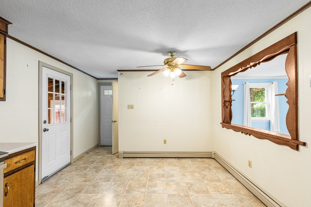 99 Swansom Road Swansea, MA 02777 - Photo 12 of 42 an empty room with a chandelier fan and windows
