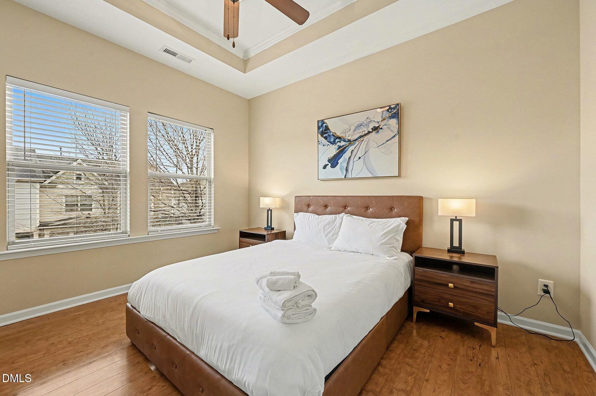 106 Kiley Street Chapel Hill, NC 27516 - Photo 14 of 17 a bedroom with a bed and wooden floor