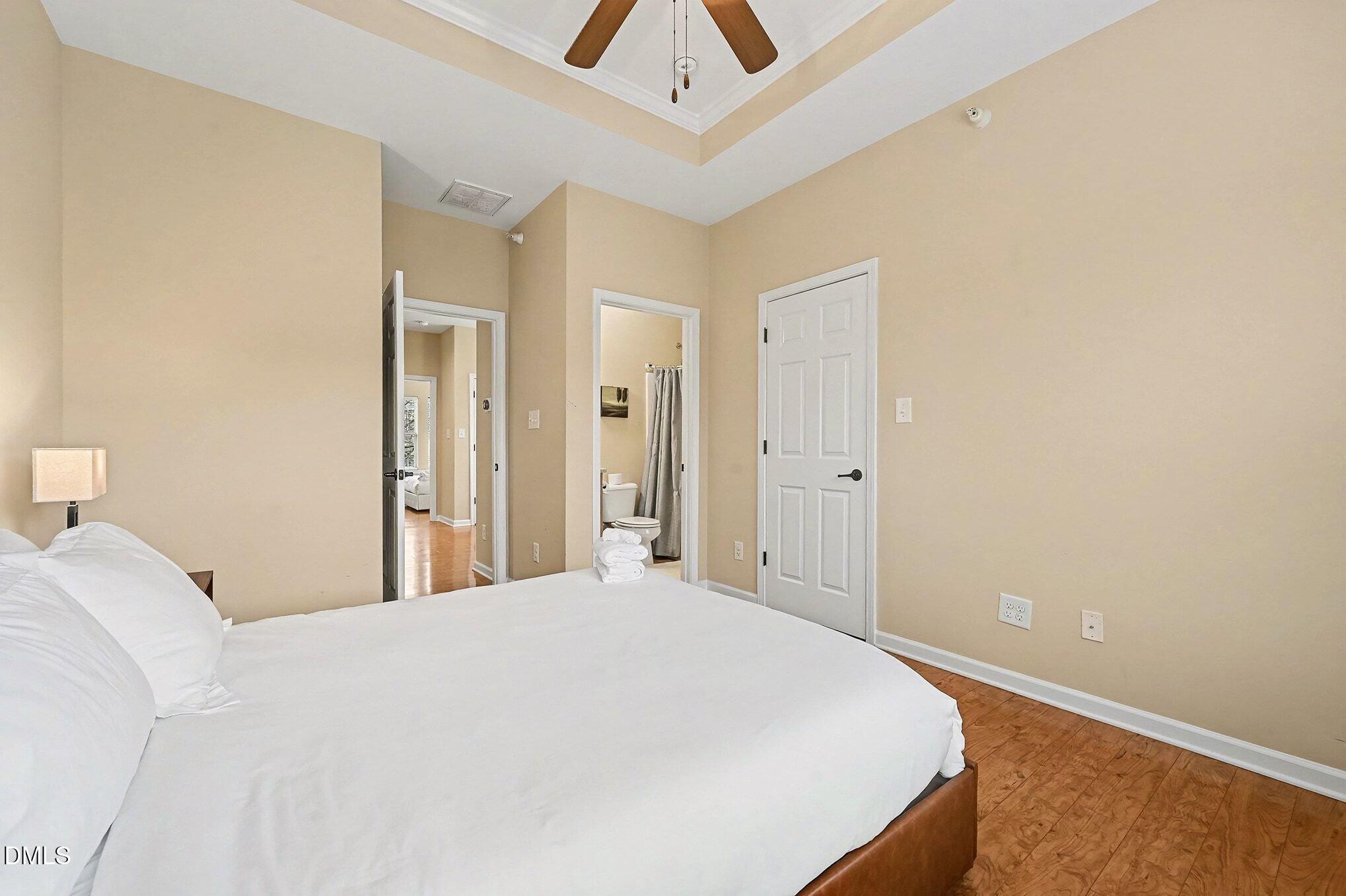 106 Kiley Street Chapel Hill, NC 27516 - Photo 15 of 17 a bedroom with a large bed and a chandelier