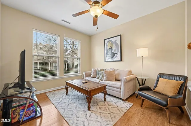 a living room with furniture and two window