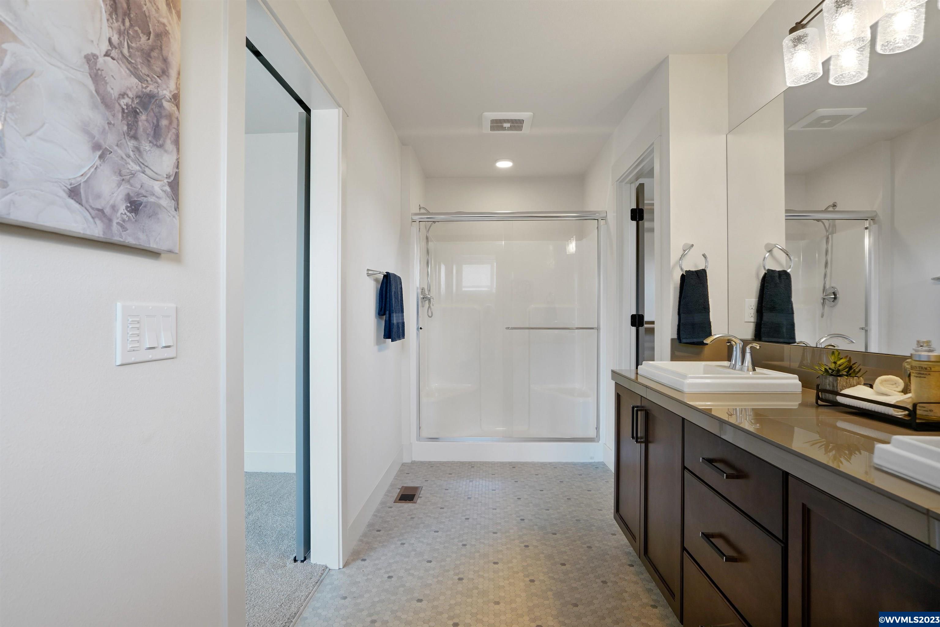 1956 Southwest 53rd Street Corvallis, OR 97333 - Photo 31 of 41 a spacious bathroom with a shower sink and mirror