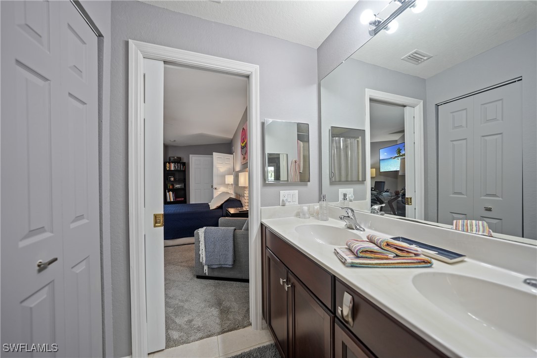 950 Moody Road, Unit 140 North Fort Myers, FL 33903 - Photo 13 of 46 a en suite bathroom with a sink double vanity and a mirror