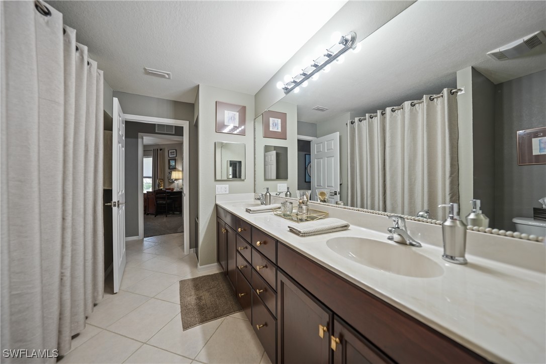950 Moody Road, Unit 140 North Fort Myers, FL 33903 - Photo 14 of 46 a spacious bathroom with a double vanity sink and a mirror