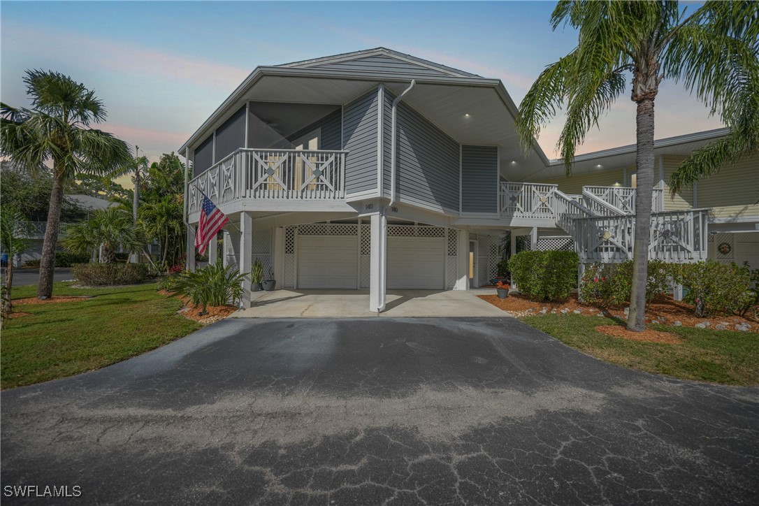 950 Moody Road, Unit 140 North Fort Myers, FL 33903 - Photo 34 of 46 a front view of a house with a yard and garage