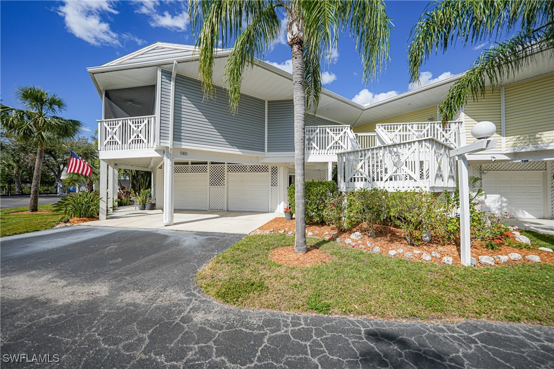 950 Moody Road, Unit 140 North Fort Myers, FL 33903 - Photo 35 of 46 a front view of a house with a yard garage and outdoor seating