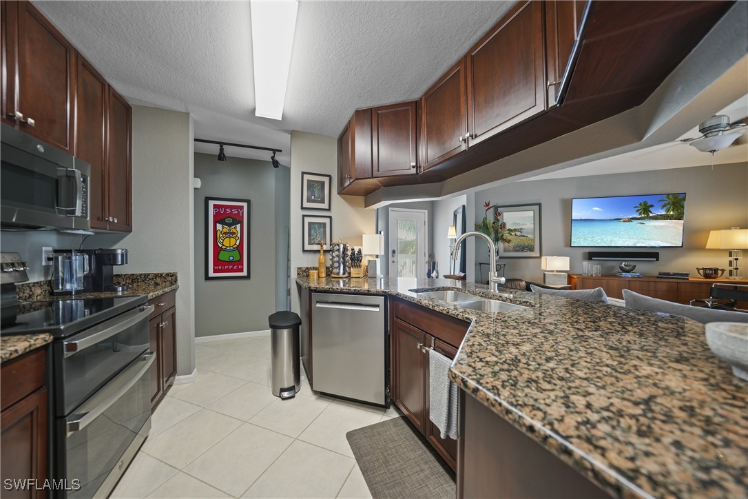 950 Moody Road, Unit 140 North Fort Myers, FL 33903 - Photo 5 of 46 a kitchen with stainless steel appliances granite countertop a sink stove and refrigerator