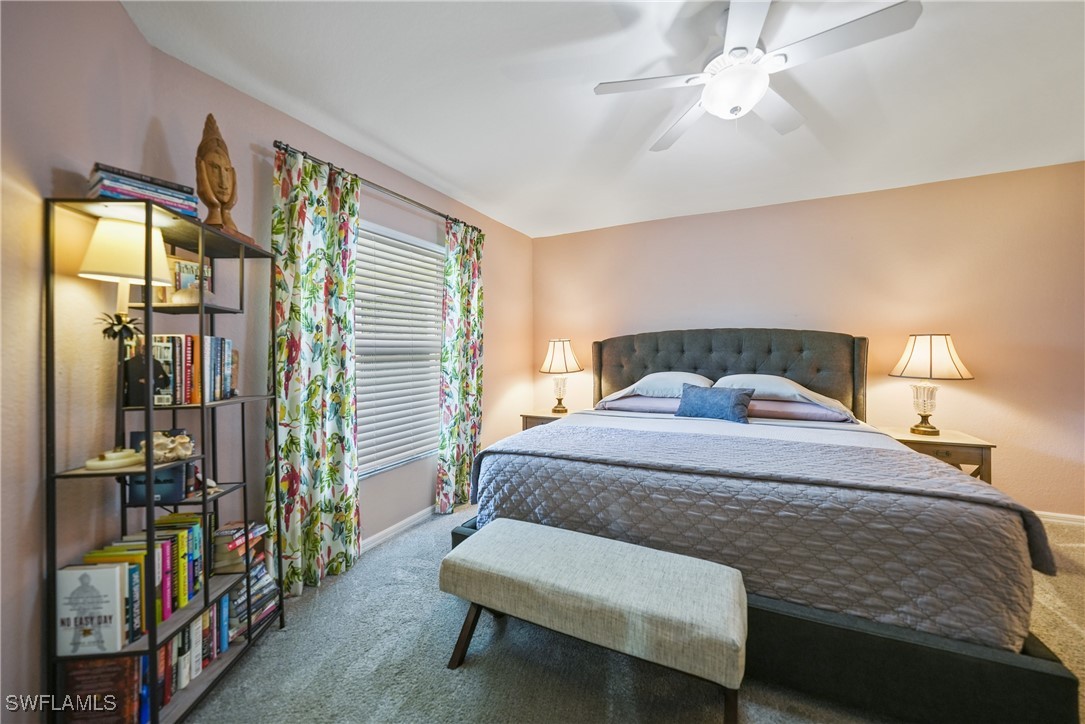 950 Moody Road, Unit 140 North Fort Myers, FL 33903 - Photo 7 of 46 a bedroom with a bed and a chandelier