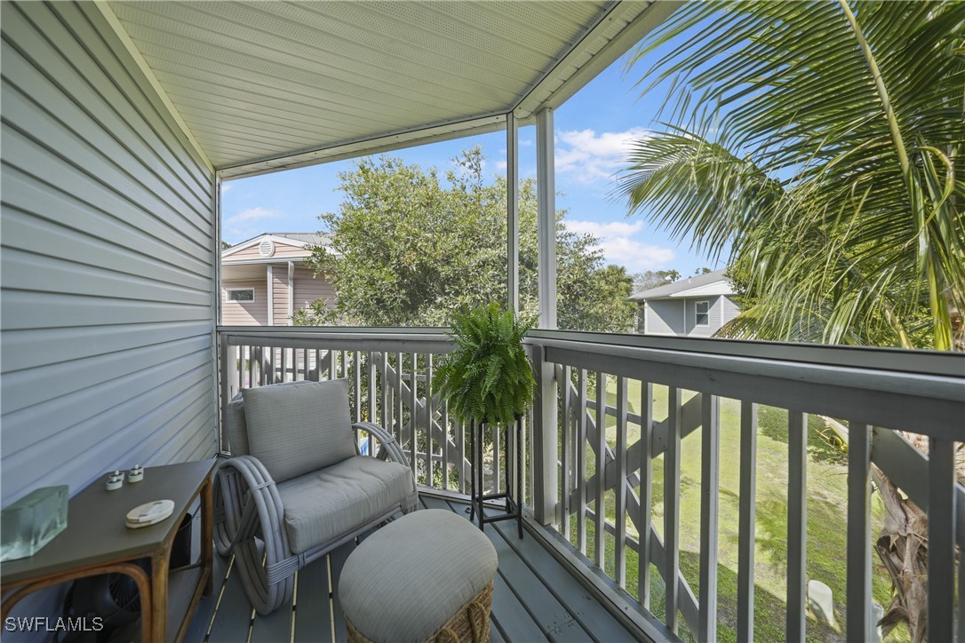 950 Moody Road, Unit 140 North Fort Myers, FL 33903 - Photo 8 of 46 a view of a balcony with chairs and wooden fence