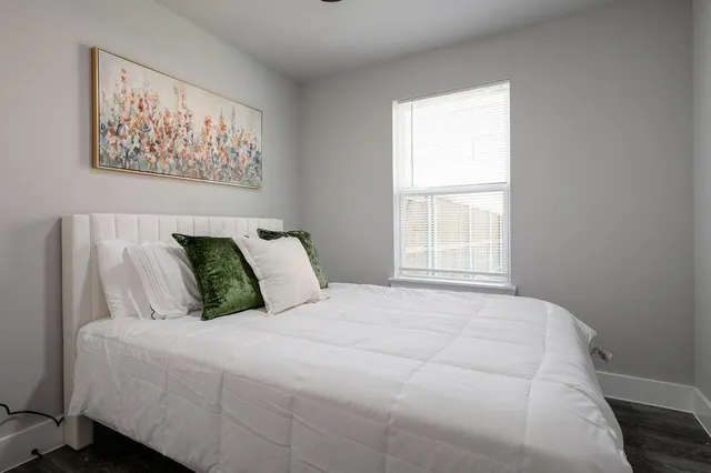 a bedroom with a bed and a window