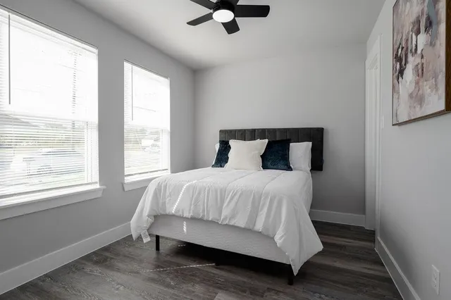 a bedroom with a bed and painting on the wall