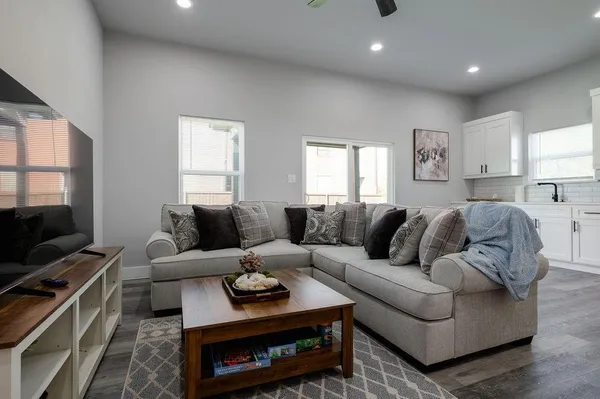 a living room with furniture a flat screen tv and a fireplace