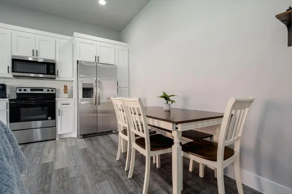 a dining room with furniture and kitchen view
