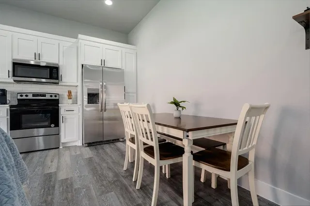 a dining room with furniture and kitchen view