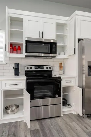 a kitchen with cabinets and stainless steel appliances