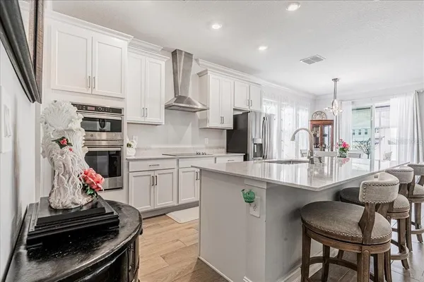a kitchen with granite countertop white cabinets and stainless steel appliances
