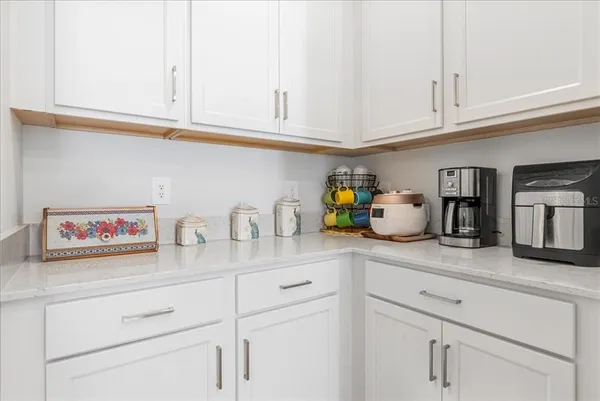 a large kitchen with stainless steel appliances a refrigerator and a stove top oven