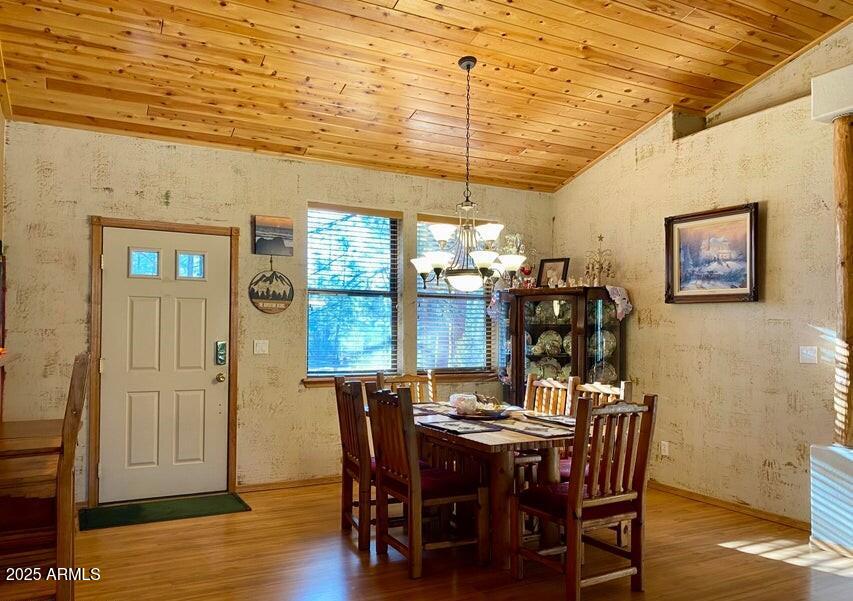 1100 South Pinon Drive Show Low, AZ 85901 - Photo 11 of 30 a view of a dining room with furniture window and wooden floor