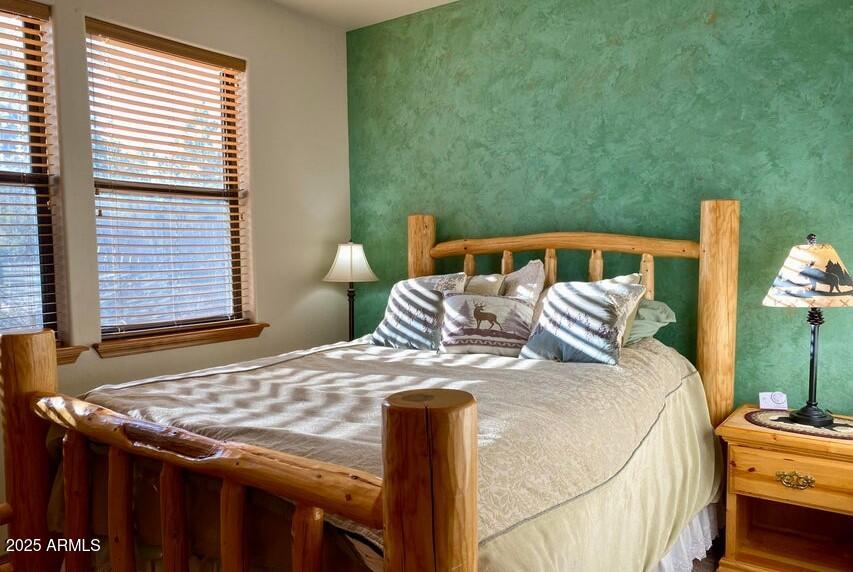 1100 South Pinon Drive Show Low, AZ 85901 - Photo 17 of 30 a bedroom with a bed and two windows