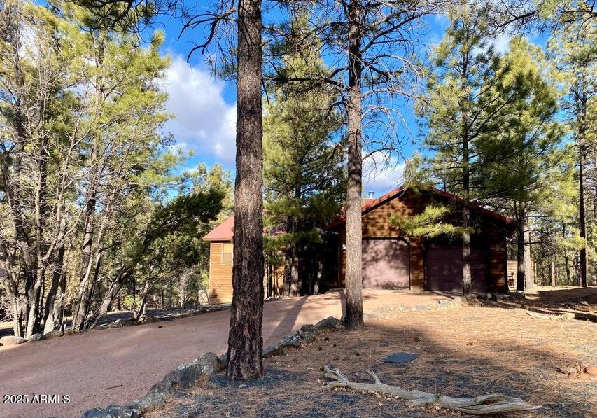 1100 South Pinon Drive Show Low, AZ 85901 - Photo 2 of 30 a street sign on a road next to a road