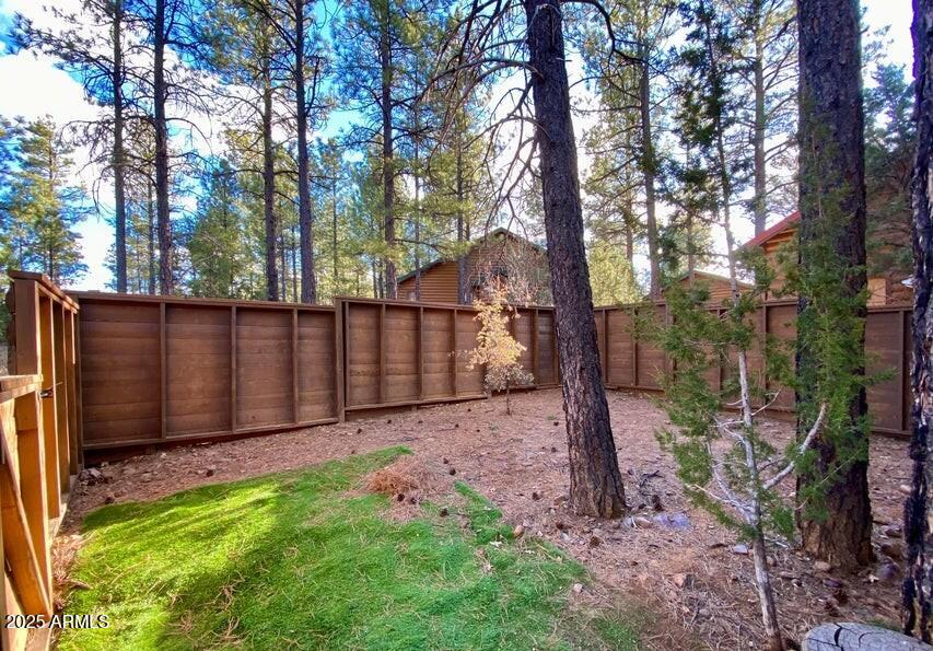 1100 South Pinon Drive Show Low, AZ 85901 - Photo 27 of 30 a view of backyard with wooden fence and a large tree