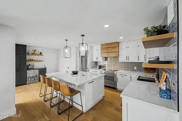 a kitchen with a sink appliances and cabinets