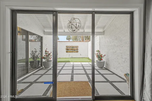 a room with pool table and a potted plant