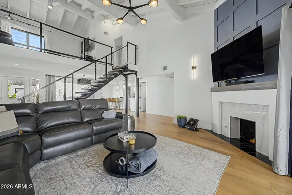 a living room with furniture a fireplace and a flat screen tv