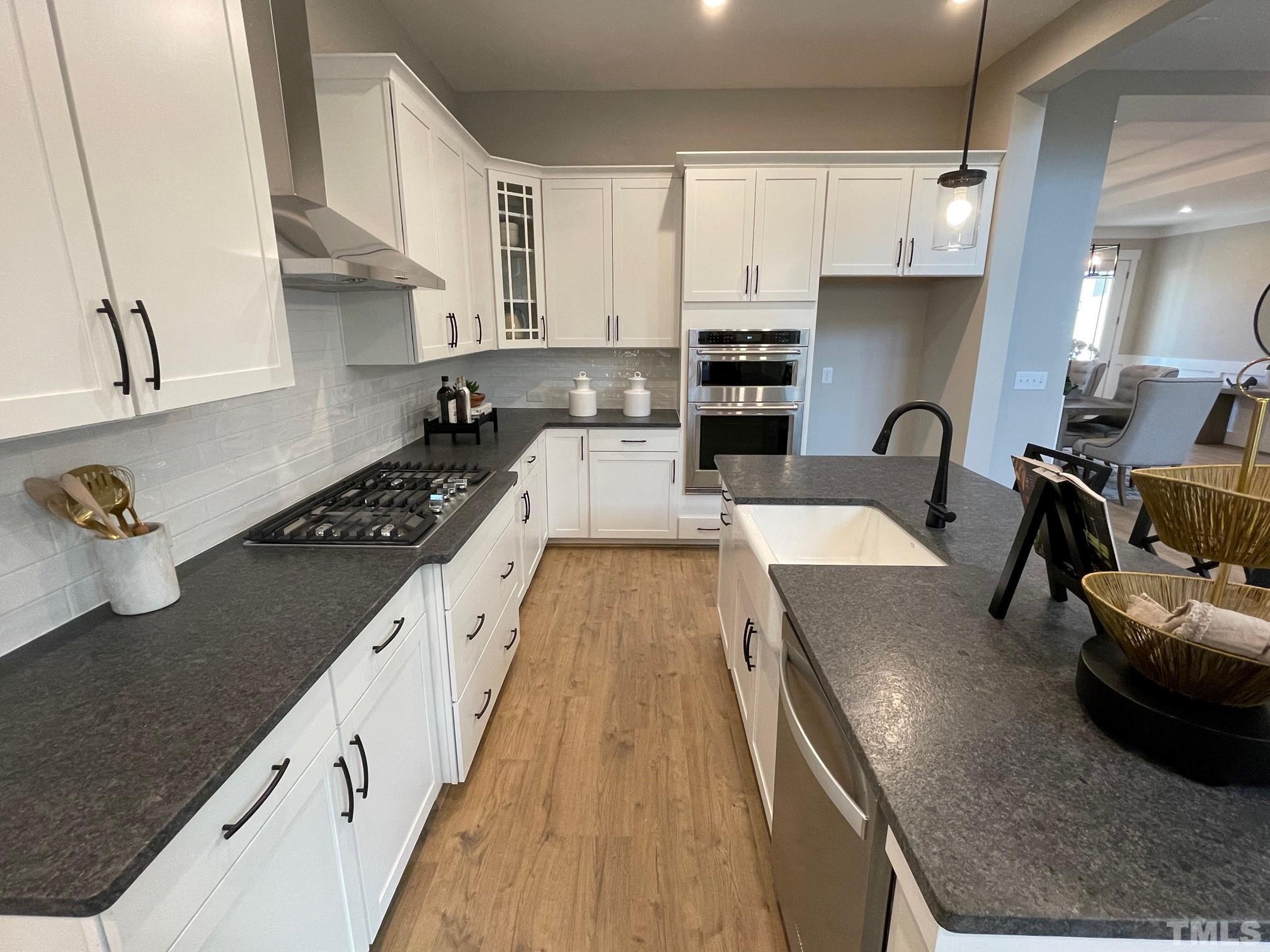 2017 Big Panther Drive Willow Spring, NC 27592 - Photo 11 of 35 a large kitchen with stainless steel appliances granite countertop a lot of counter space and a sink