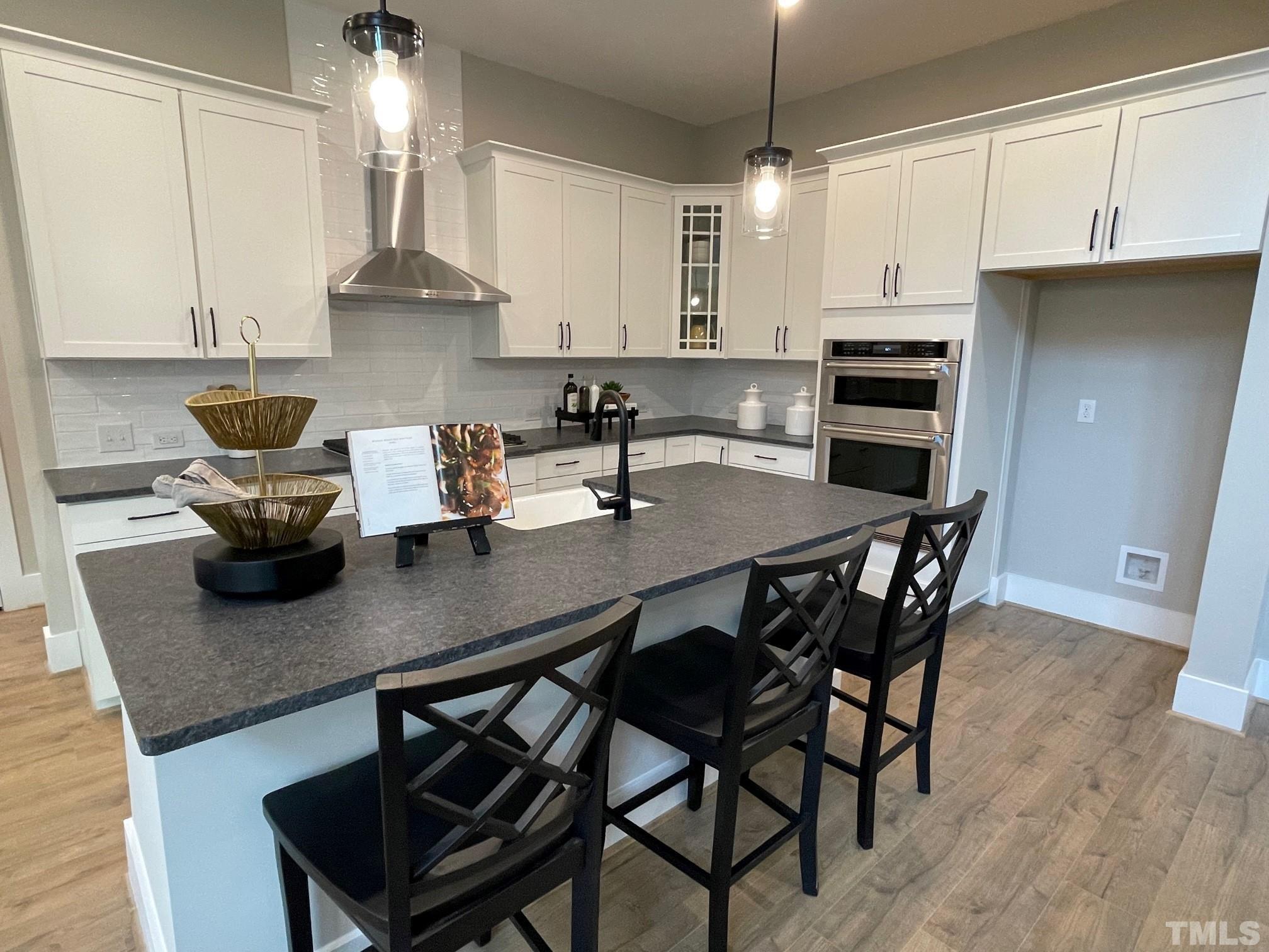 2017 Big Panther Drive Willow Spring, NC 27592 - Photo 12 of 35 a kitchen with a dining table chairs and cabinets