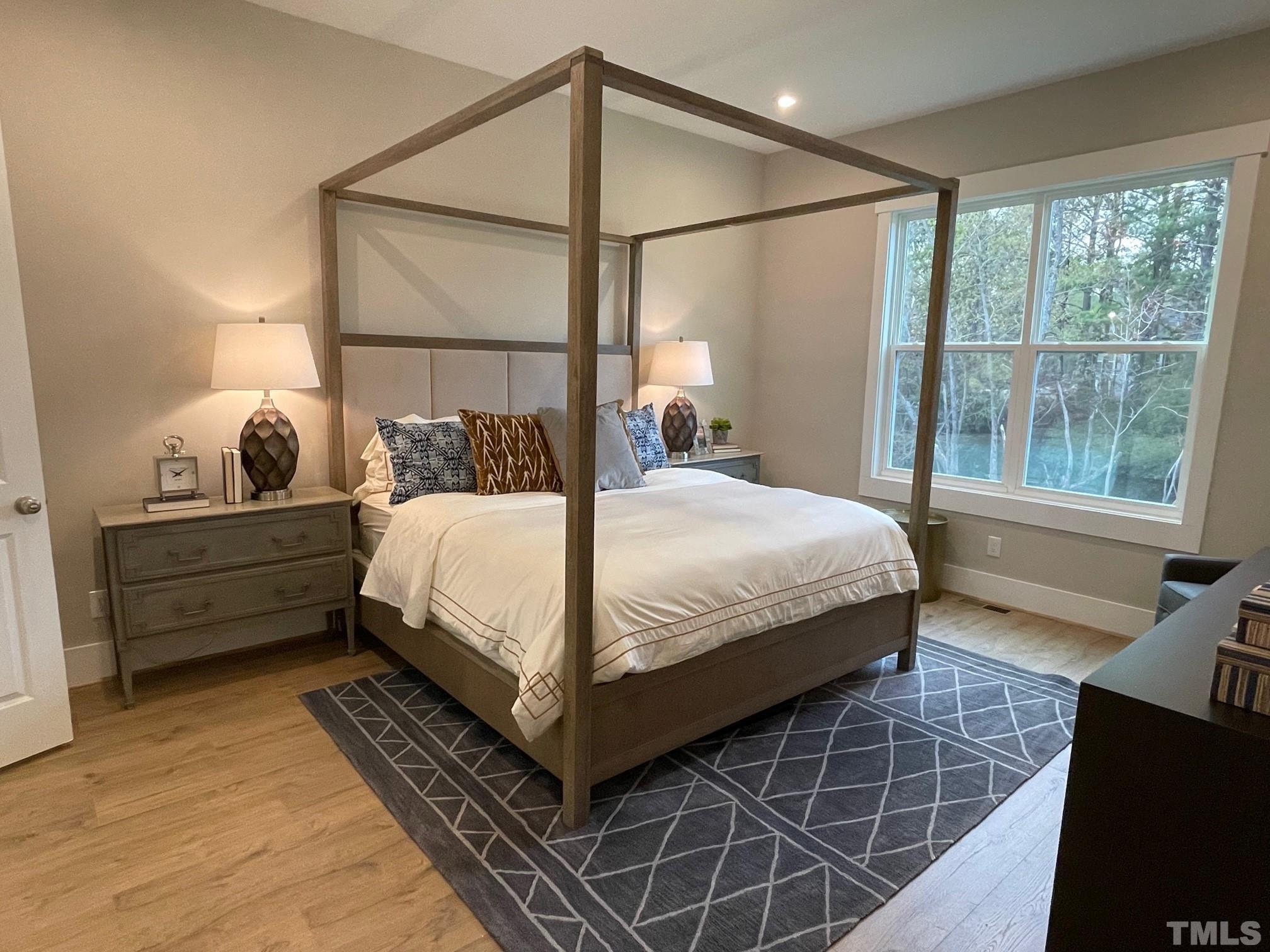 2017 Big Panther Drive Willow Spring, NC 27592 - Photo 16 of 35 a bedroom with a bed and wooden floor