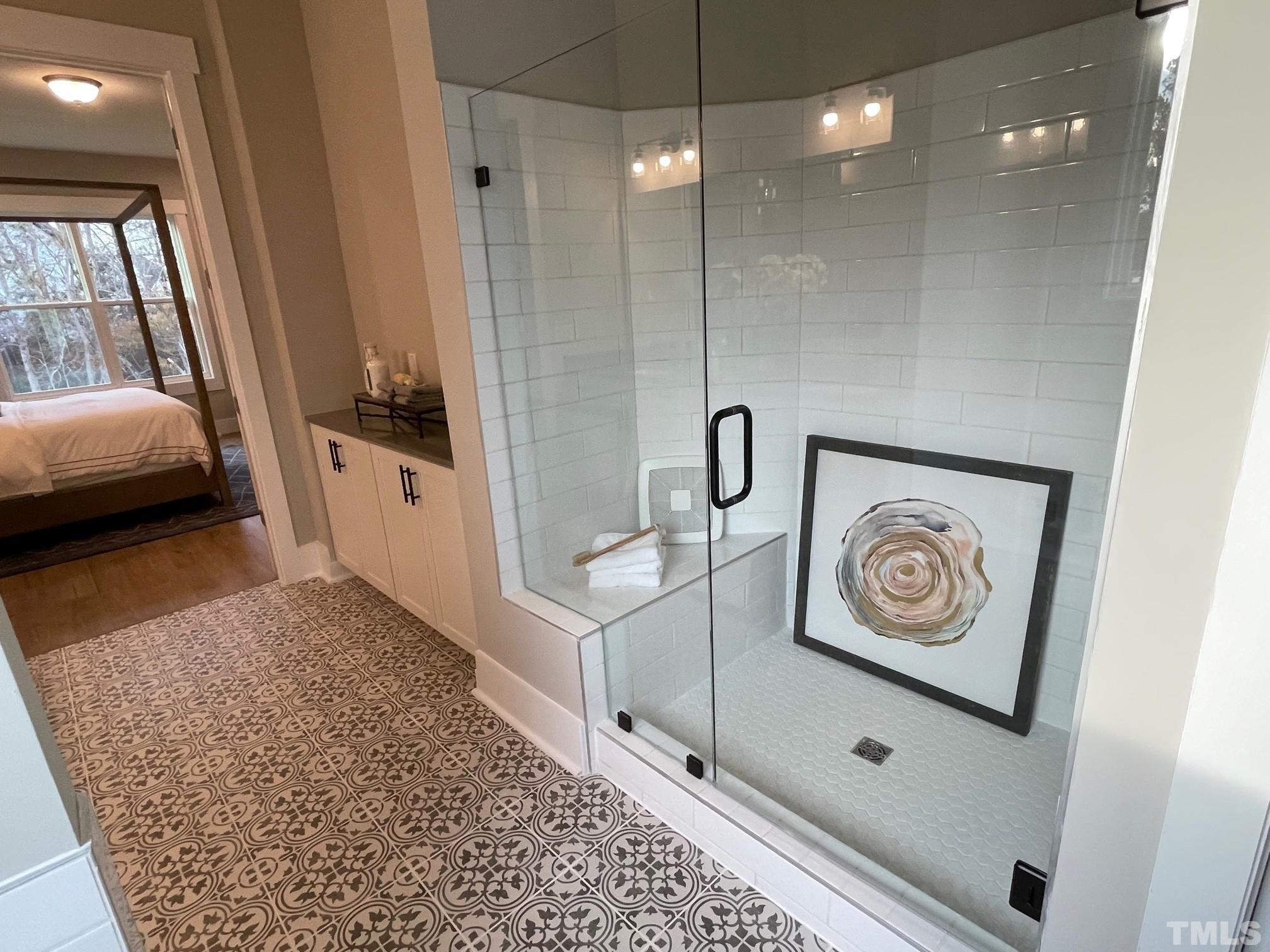 2017 Big Panther Drive Willow Spring, NC 27592 - Photo 22 of 35 a bathroom with a sink a mirror and a shower