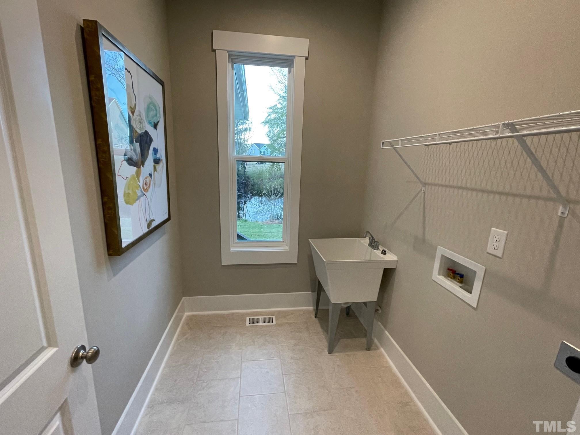 2017 Big Panther Drive Willow Spring, NC 27592 - Photo 26 of 35 a view of a bathroom with a bathtub and window