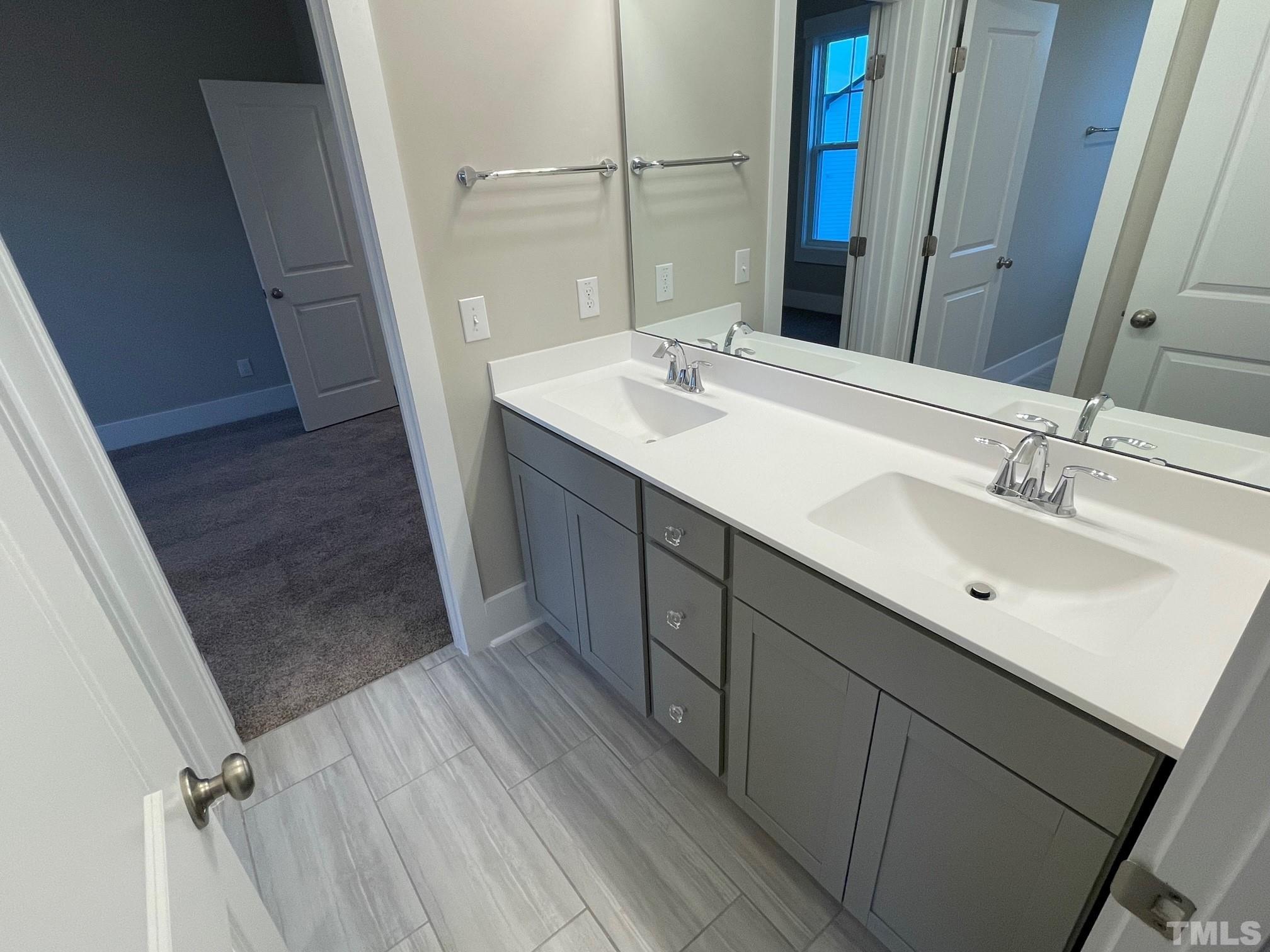 2017 Big Panther Drive Willow Spring, NC 27592 - Photo 27 of 35 a bathroom with a double vanity sink a and mirror