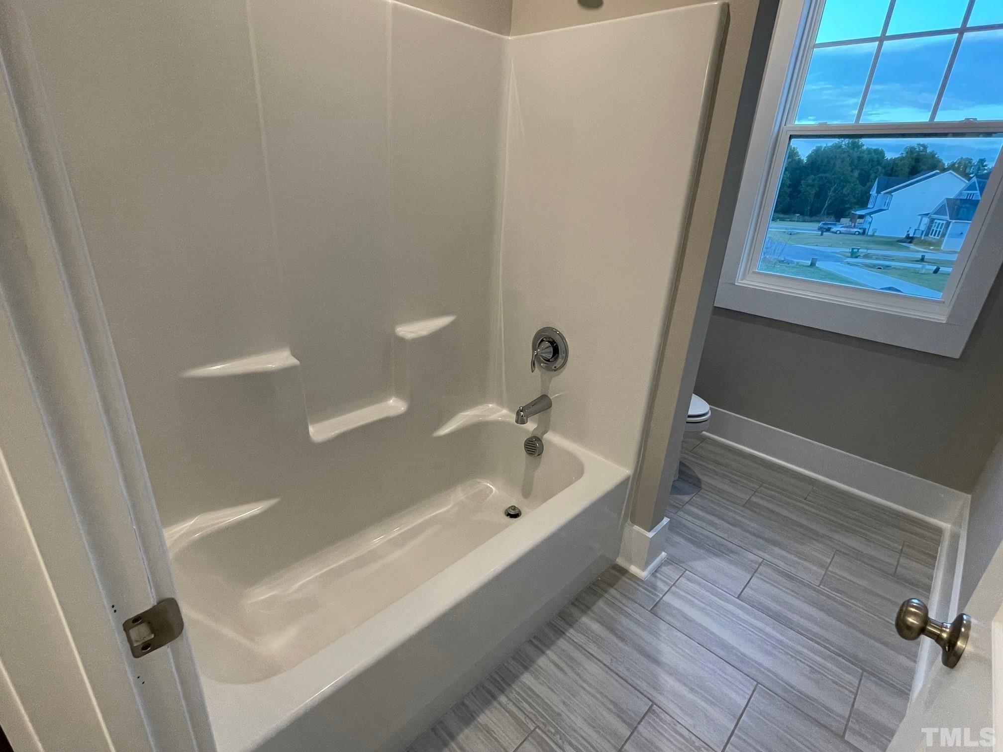 2017 Big Panther Drive Willow Spring, NC 27592 - Photo 28 of 35 a bathroom with a bathtub and a shower