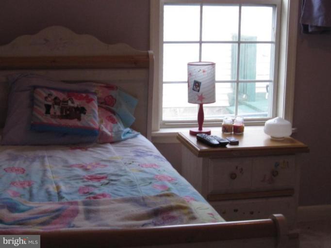 1918 Perryman Road Aberdeen, MD 21001 - Photo 11 of 25 a bed sitting in a bedroom next to a window