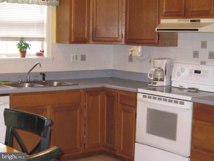 1918 Perryman Road Aberdeen, MD 21001 - Photo 7 of 25 a kitchen with granite countertop cabinets stainless steel appliances and a sink