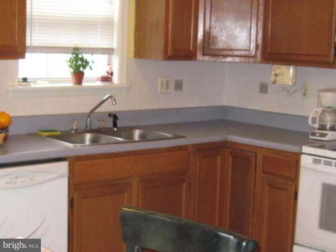 1918 Perryman Road Aberdeen, MD 21001 - Photo 9 of 25 a kitchen with stainless steel appliances granite countertop wooden cabinets a sink and dishwasher