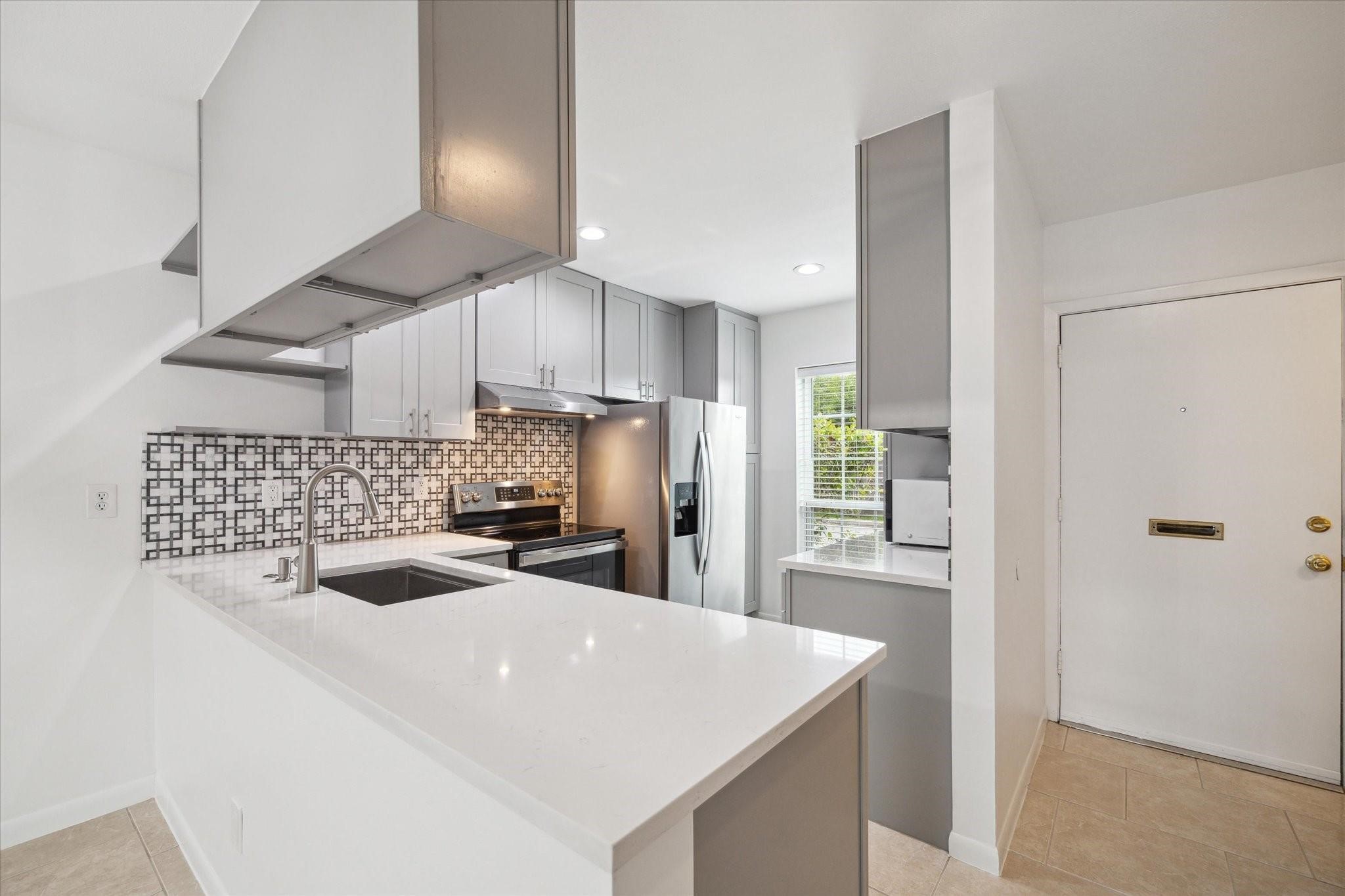 7821 Rue St Cyr Street, Unit 55 Houston, TX 77074 - Photo 2 of 16 Beautifully remodeled kitchen with quartz countertops and modern cabinetry.