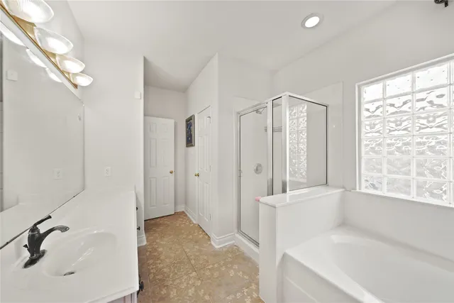 a bathroom with a tub sink and window