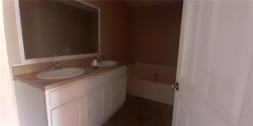 51 Pine Avenue Commerce, GA 30529 - Photo 13 of 24 a bathroom with a sink and a mirror