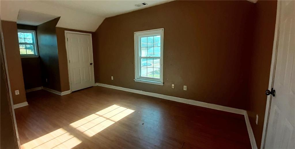 51 Pine Avenue Commerce, GA 30529 - Photo 15 of 24 an empty room with wooden floor and windows