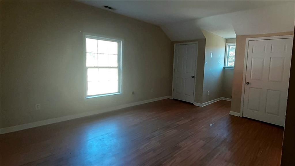 51 Pine Avenue Commerce, GA 30529 - Photo 18 of 24 an empty room with wooden floor and windows