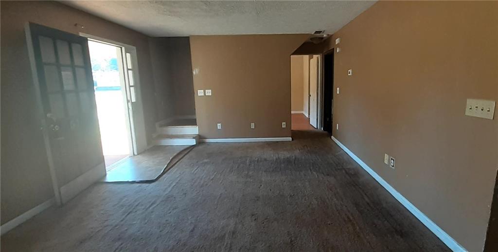 51 Pine Avenue Commerce, GA 30529 - Photo 5 of 24 wooden floor in an empty room with a window