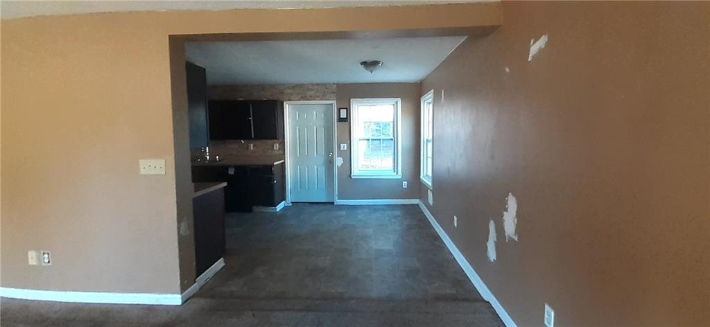 51 Pine Avenue Commerce, GA 30529 - Photo 7 of 24 a view of hallway with stairs and wooden floor
