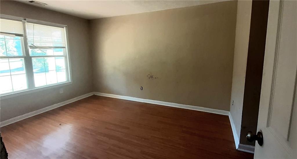 51 Pine Avenue Commerce, GA 30529 - Photo 10 of 24 an empty room with wooden floor and windows